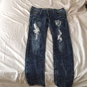 Skinny jeans ripped from thighs.